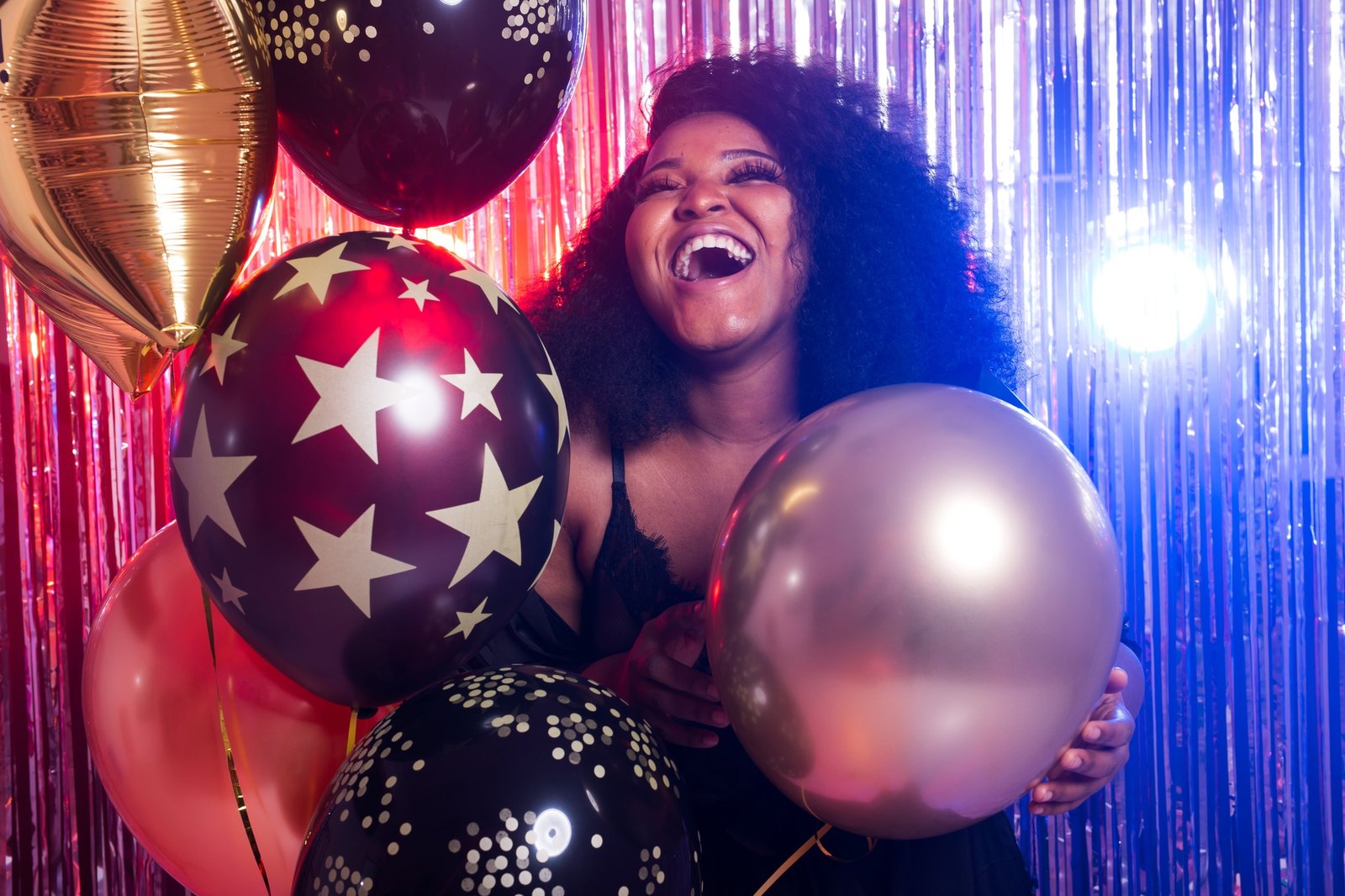 Portrait of a beautiful african american woman against twinkling background. Birthday party